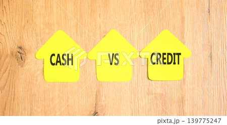 Cash vs credit words symbol. Concept words Cash vs credit on beautiful yellow paper houses. Beautiful wooden background. Business and cash vs credit concept. Copy space. Cash vs credit words symbol. Concept words Cash vs credit on beautiful yellow paper houses. Beautiful wooden background. Business and cash vs credit concept. Copy space. 139775247