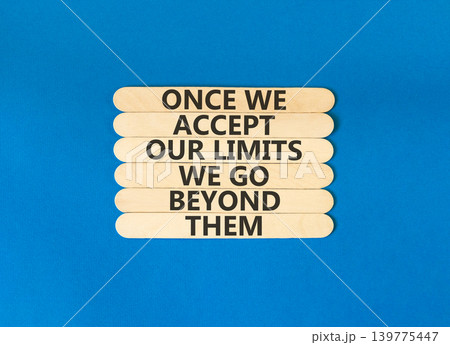 Beyond limits symbol. Concept words Once we accept our limits we go beyond them on wooden Sticks. Beautiful blue background. Business Once we accept our limits we go beyond them concept. Copy space. Beyond limits symbol. Concept words Once we accept our limits we go beyond them on wooden Sticks. Beautiful blue background. Business Once we accept our limits we go beyond them concept. Copy space. 139775447