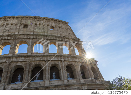 Famous Coliseum in Rome. Colosseum, or Coliseum. Sunset at huge Roman amphitheatre, Rome, Italy, Europe. Famous touristic place in the world and Europe. Beautiful blue sky background. Famous Coliseum in Rome. Colosseum, or Coliseum. Sunset at huge Roman amphitheatre, Rome, Italy, Europe. Famous touristic place in the world and Europe. Beautiful blue sky background. 139775470