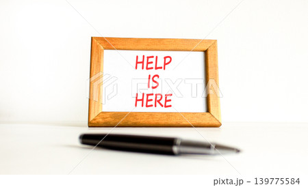 Help is here and support words symbol. Concept words Help is here on beautiful wooden picture frame. Beautiful white background. Business help is here and support concept. Copy space. Help is here and support words symbol. Concept words Help is here on beautiful wooden picture frame. Beautiful white background. Business help is here and support concept. Copy space. 139775584
