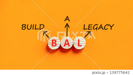 BAL build a legacy symbol. Concept words BAL build a legacy on beautiful wooden circles. Beautiful orange background. Business BAL build a legacy concept. Copy space 139775642