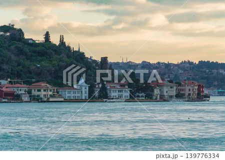 Bosphorus Waterfront Homes Beneath Cloudy Evening Sky in Istanbul, Turkey. 139776334