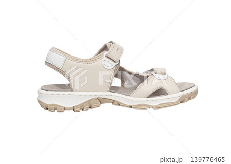 A pair of casual beige and white sandals with adjustable straps and cushioned sole, isolated on a white background. 139776465
