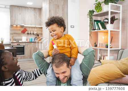 Happy multiracial family enjoying playful time at home together Happy multiracial family enjoying playful time at home together 139777608