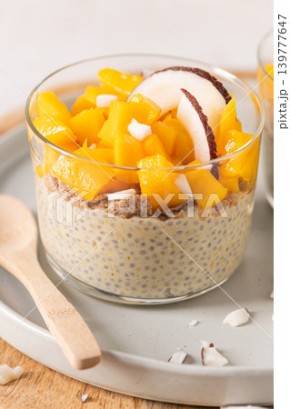 Creamy chia seed pudding topped with fresh diced mango and coconut slices served in a glass bowl for a healthy breakfast or tropical vegan dessert on a bright and airy rustic table setting Creamy chia seed pudding topped with fresh diced mango and coconut slices served in a glass bowl for a healthy breakfast or tropical vegan dessert on a bright and airy rustic table setting 139777647