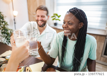 Celebrating friendship with cheers at a cozy dining table 139777821