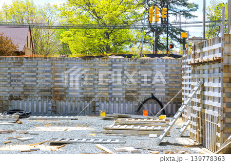 Workers prepare construction site with concrete forms tools while during foundation works Workers prepare construction site with concrete forms tools while during foundation works 139778363