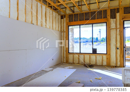 Workers are preparing space for future construction with drywall open framing inside. Workers are preparing space for future construction with drywall open framing inside. 139778385