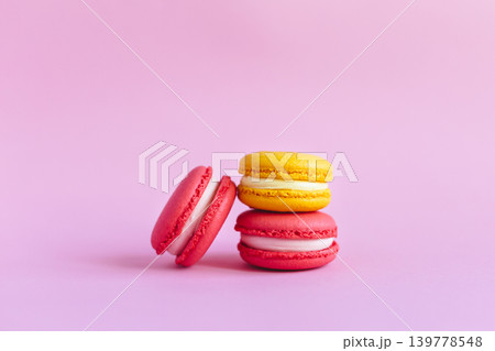 Three tasty french macarons on pink background. Three tasty french macarons on pink background. 139778548