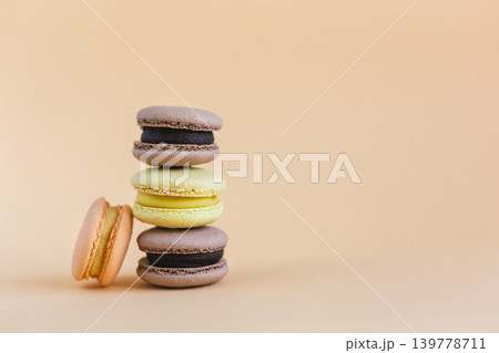 Tasty french macarons on a peach pastel background. 139778711