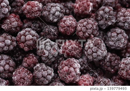 Frozen blackberries covered in frost creating a winter food background Frozen blackberries covered in frost creating a winter food background 139779493