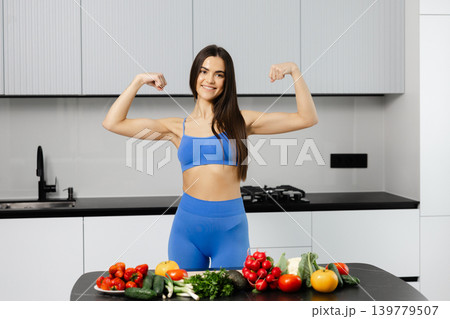 Woman flexing biceps promoting healthy eating and fitness 139779507