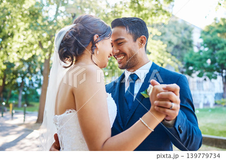 Dance, holding hands and couple at wedding outdoor for marriage, love or smile in nature. Bride, groom and people with affection, partner and support with connection, trust and peace in park Dance, holding hands and couple at wedding outdoor for marriage, love or smile in nature. Bride, groom and people with affection, partner and support with connection, trust and peace in park 139779734