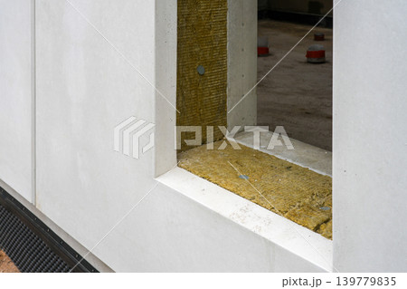 Modular house prefab panel window detail with mineral wool insulation layer under construction Modular house prefab panel window detail with mineral wool insulation layer under construction 139779835