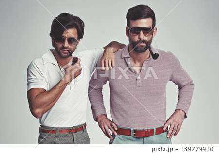Fashion, men and sunglasses or pipe with vintage model, hipster outfit or confidence with calm expression in studio. Friends, people and attitude with 70s style or retro clothes with white background Fashion, men and sunglasses or pipe with vintage model, hipster outfit or confidence with calm expression in studio. Friends, people and attitude with 70s style or retro clothes with white background 139779910