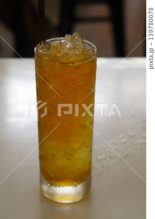 Orange Beverage with Ice in Glass Orange Beverage with Ice in Glass 139780078