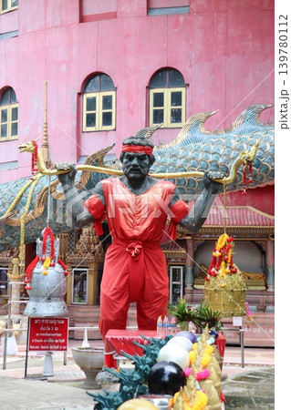 Red-clad Statue with Dragon in Front of Pink Building 139780112