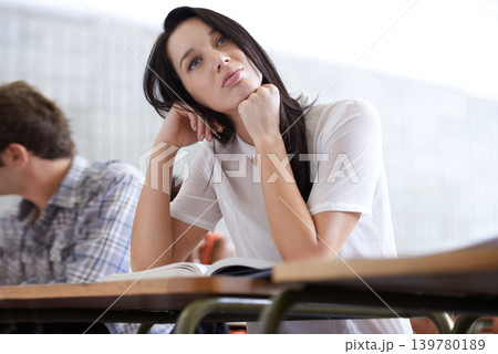 University, thinking and woman in classroom with books for development in learning, opportunity and future. Education, knowledge and growth for college student in lecture, studying for exam or test. University, thinking and woman in classroom with books for development in learning, opportunity and future. Education, knowledge and growth for college student in lecture, studying for exam or test. 139780189