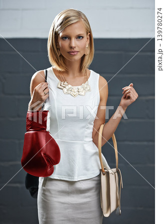 Woman, portrait and fashion with bags or boxing gloves or designer style with exercise equipment, confidence or beauty. Female person, face and workout gear for fighter cardio shopping or challenge Woman, portrait and fashion with bags or boxing gloves or designer style with exercise equipment, confidence or beauty. Female person, face and workout gear for fighter cardio shopping or challenge 139780274