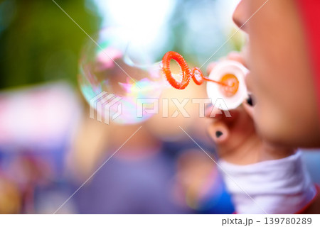 Closeup, blowing bubbles and outdoor with woman, summer and weekend break with event. Party, person and girl in a park and happy with soap toy and bokeh background with nature, rainbow and festival Closeup, blowing bubbles and outdoor with woman, summer and weekend break with event. Party, person and girl in a park and happy with soap toy and bokeh background with nature, rainbow and festival 139780289
