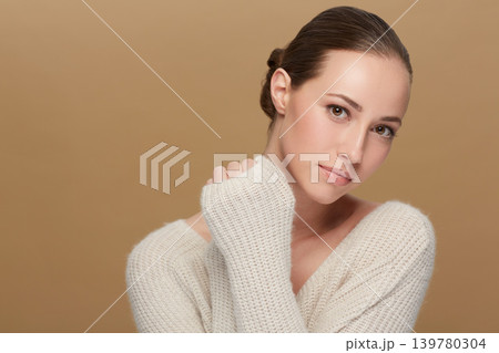 Winter, beauty or portrait of natural model in studio isolated on brown background for fashion or wellness. Face, skincare or space with confident woman or happy person in wool jersey or sweater Winter, beauty or portrait of natural model in studio isolated on brown background for fashion or wellness. Face, skincare or space with confident woman or happy person in wool jersey or sweater 139780304