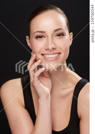 Studio, portrait and cosmetics of woman with happiness, cosmetic and facial treatment on black background. Model, smile and make up for spa beauty for glow body, skincare and collagen for soft skin Studio, portrait and cosmetics of woman with happiness, cosmetic and facial treatment on black background. Model, smile and make up for spa beauty for glow body, skincare and collagen for soft skin 139780344