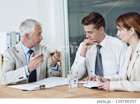 Business people, leader or planning on paperwork for collaboration, strategy or notes at office. Senior CEO, teamwork or employees with documents or report in meeting for brainstorming at workplace 139780357