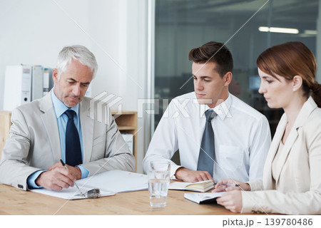 Business people, writing and planning on paperwork for collaboration, strategy or notes at office. Group, teamwork or employees with documents or paperwork in meeting for brainstorming at workplace 139780486