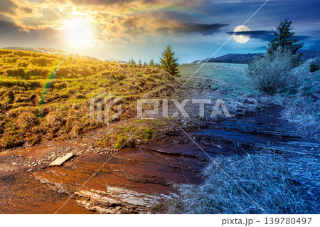day meet night. rural scenery in carpathian mountains. sun and moon over simple view of a countryside mountain landscape during springtime at twilight. brook near the grassy hills. harmony concept day meet night. rural scenery in carpathian mountains. sun and moon over simple view of a countryside mountain landscape during springtime at twilight. brook near the grassy hills. harmony concept 139780497