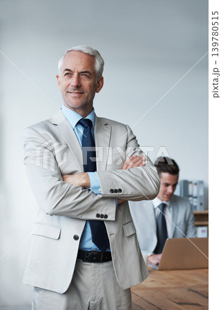 Senior businessman, professional and confidence in leadership, agency and pride for mentoring in office. Male person, arms crossed and smile for support in management, advisor and laptop for planning Senior businessman, professional and confidence in leadership, agency and pride for mentoring in office. Male person, arms crossed and smile for support in management, advisor and laptop for planning 139780515