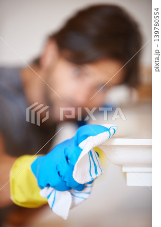 Cloth, glove and cleaning for hygiene with cleaner person, disinfection and sanitize for housekeeping. Dust, dirt or germs with bacteria, closeup of fabric for maintenance and janitor wipe surface 139780554