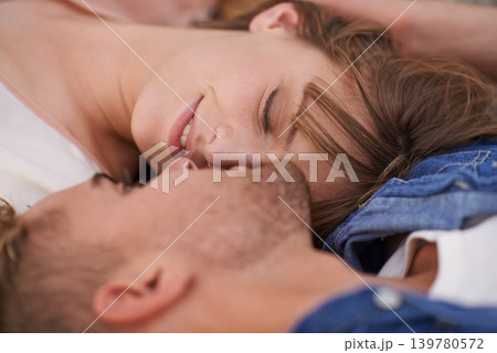 Closeup, couple and love with care while lying down for bonding at home. Man, woman and relax in relationship with affection and intimate romance in a calm and peaceful house for leisure with zoom 139780572
