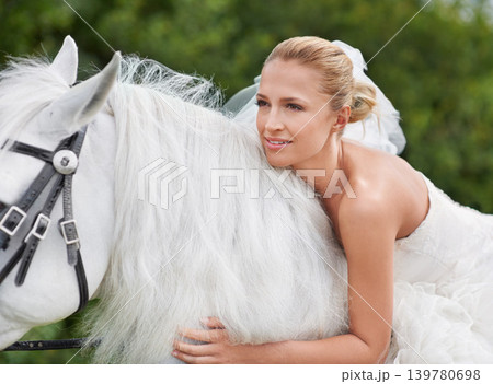 Wedding, woman and riding with horse in nature and happy for celebration, marriage and confidence in countryside. Bride, person and stallion on lawn in field with smile, dress and animal at ceremony Wedding, woman and riding with horse in nature and happy for celebration, marriage and confidence in countryside. Bride, person and stallion on lawn in field with smile, dress and animal at ceremony 139780698