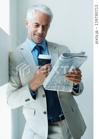 Businessman, newspaper and reading with coffee for information as lawyer for article, morning or research. Male person, hot drink and corporate review in Canada for international, newsletter or press Businessman, newspaper and reading with coffee for information as lawyer for article, morning or research. Male person, hot drink and corporate review in Canada for international, newsletter or press 139780713