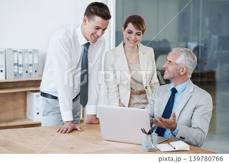 Laptop, meeting and business people in discussion in office for corporate legal project. Conversation, technology and professional team of lawyers working on computer by desk together in workplace. 139780766