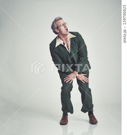 Retro, fashion and man dancing in studio happy attitude, fun and groovy suit on mockup space. Funky clothes, playful and mature person with vintage style, unique and excited on white background. Retro, fashion and man dancing in studio happy attitude, fun and groovy suit on mockup space. Funky clothes, playful and mature person with vintage style, unique and excited on white background. 139780825