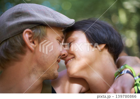 Couple, closeup and embrace outdoors for date with wristband for festival, concert or adventure together. Man, woman and smile with flat cap for summer in nature, forest or woods with happiness Couple, closeup and embrace outdoors for date with wristband for festival, concert or adventure together. Man, woman and smile with flat cap for summer in nature, forest or woods with happiness 139780866