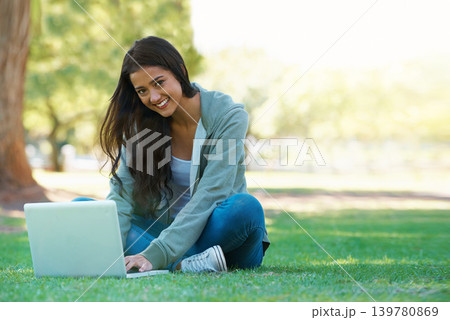 College, woman and typing on laptop in park with research, project or learning outdoor on campus. University, student and girl studying online with ebook, education and computer on lawn in garden 139780869