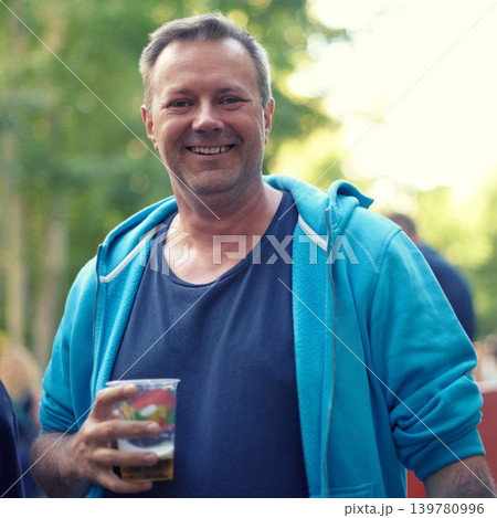 Portrait, beer and man at outdoor party, celebration or happy adventure at holiday event in Germany. Smile, drinks and nature, mature person on vacation to relax with alcohol at Munich festival. Portrait, beer and man at outdoor party, celebration or happy adventure at holiday event in Germany. Smile, drinks and nature, mature person on vacation to relax with alcohol at Munich festival. 139780996