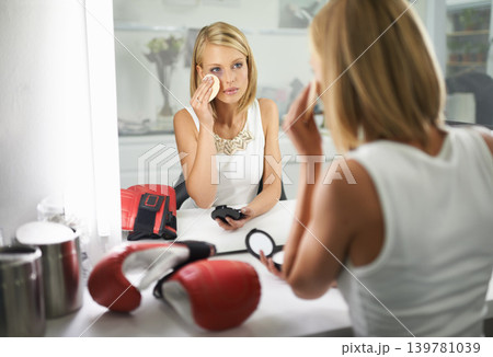 Woman, bruise and boxing gloves by mirror, makeup and stylish outfit in dressing room. Female person, blush and eyeshadow for sport match, reflection and fashion to prepare for post interview 139781039