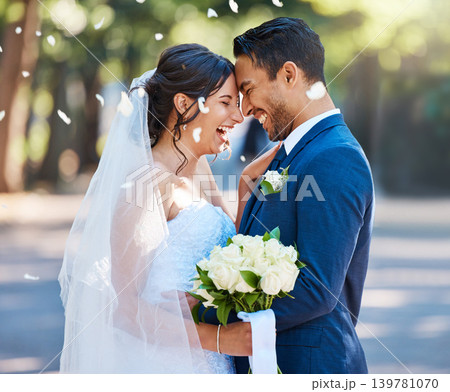 Smile, couple and confetti at wedding with love, romantic ceremony and commitment celebration. Laugh, bride and groom with bokeh, partnership and emotional connection at special occasion for marriage 139781070