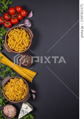 Italian pasta ingredients on dark background with copy space Italian pasta ingredients on dark background with copy space 139781375