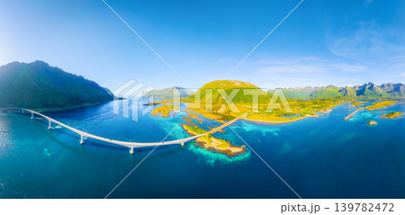 Drone view of a bridge over a fjord, Lofoten Islands, Norway. Panoramic view of the northern summer. Drone view of a bridge over a fjord, Lofoten Islands, Norway. Panoramic view of the northern summer. 139782472