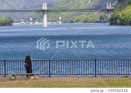 初夏の湖を撮影する女性　八ッ場あがつま湖 139782526