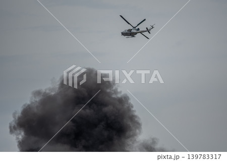 Cherry Point, North Carolina - May 9 2026: UH-1Y Venom flies above pyrotechnic smoke Cherry Point, North Carolina - May 9 2026: UH-1Y Venom flies above pyrotechnic smoke 139783317