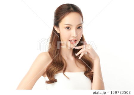 A beautiful young Asian woman with clean, fresh skin against a white background. Skincare, facial treatment, cosmetology, beauty, and spa. An elegant portrait of an Asian woman. A beautiful young Asian woman with clean, fresh skin against a white background. Skincare, facial treatment, cosmetology, beauty, and spa. An elegant portrait of an Asian woman. 139783508