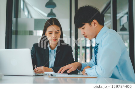 group of business people working and communicating together in the office With the charging of graphs for analysis, conceptual analysis and business planning 139784400