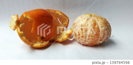 Fresh peeled oranges and citrus fruit peel on white background. Fresh peeled oranges and citrus fruit peel on white background. 139784598