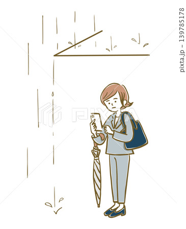 雨宿り中にスマホで連絡をするスーツ姿の女性 雨宿り中にスマホで連絡をするスーツ姿の女性 139785178