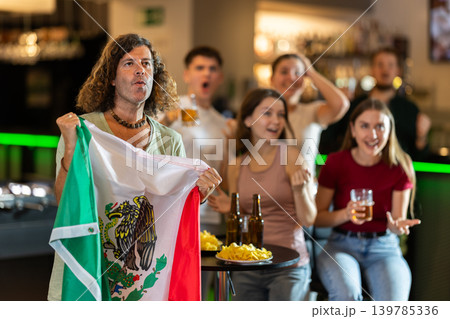Group of fans in bar with Mexican flag Group of fans in bar with Mexican flag 139785336